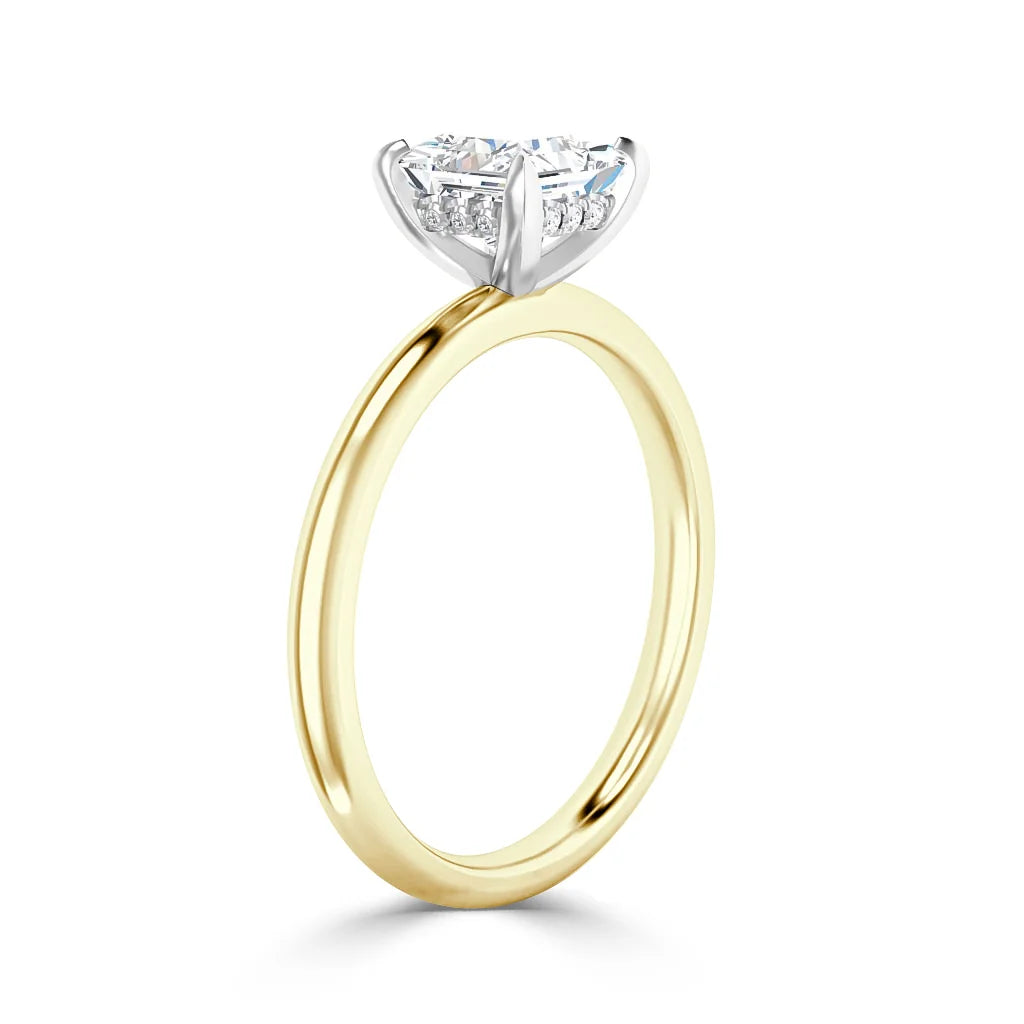 Gold band solitaire ring with a round, prong-set diamond in a white gold setting, shown on a white background.