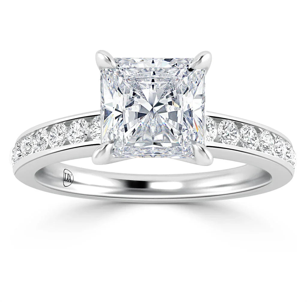A platinum ring with a large princess-cut diamond and smaller diamonds set along the band.
