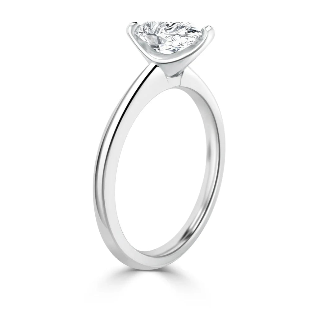 A solitaire diamond engagement ring with a round-cut diamond in a prong setting on a simple band.
