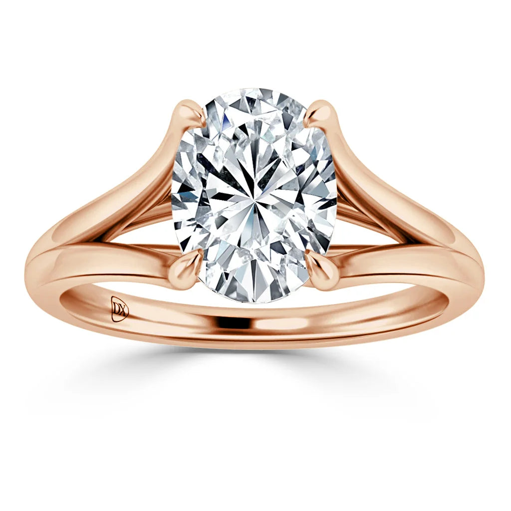 A rose gold ring with a large oval diamond set in a split shank band, shown on a white background.