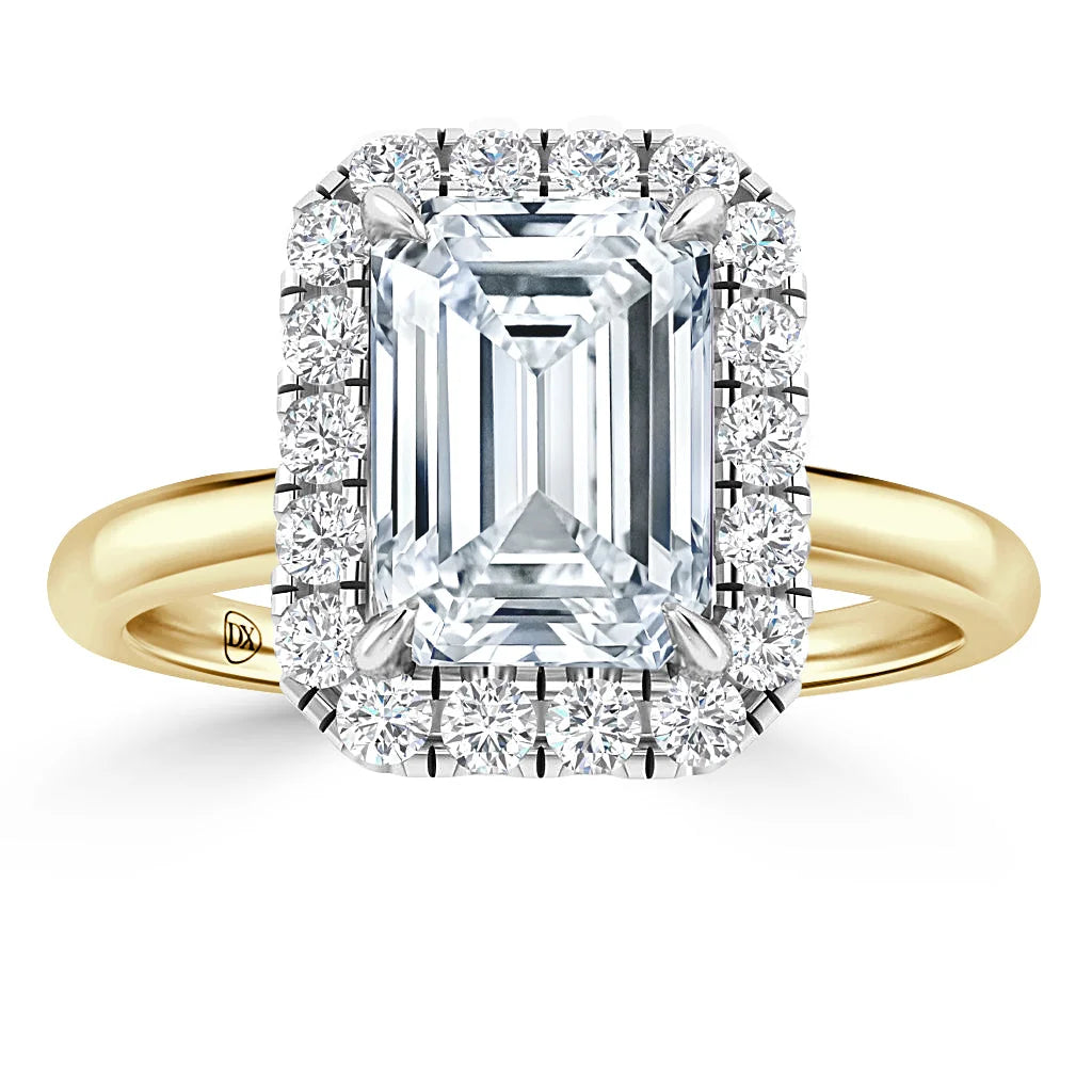Gold ring with a large emerald-cut diamond, surrounded by a halo of smaller round diamonds.