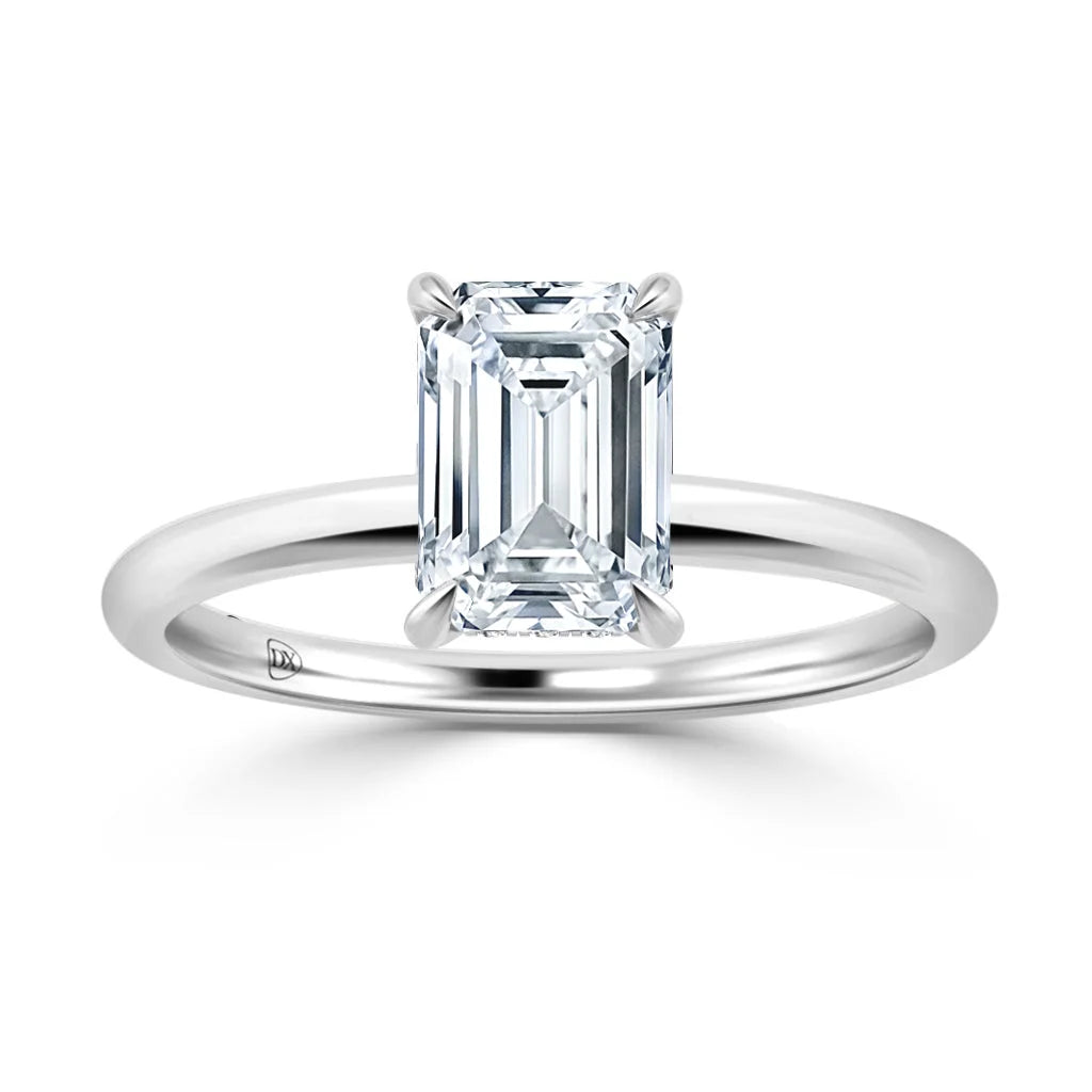 A silver ring with a large emerald-cut diamond set in a simple, elegant solitaire setting.
