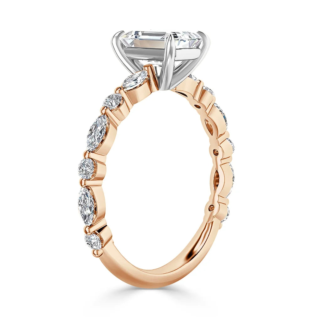 Rose gold ring with marquise-cut diamonds along the band and a large round center stone in a prong setting.