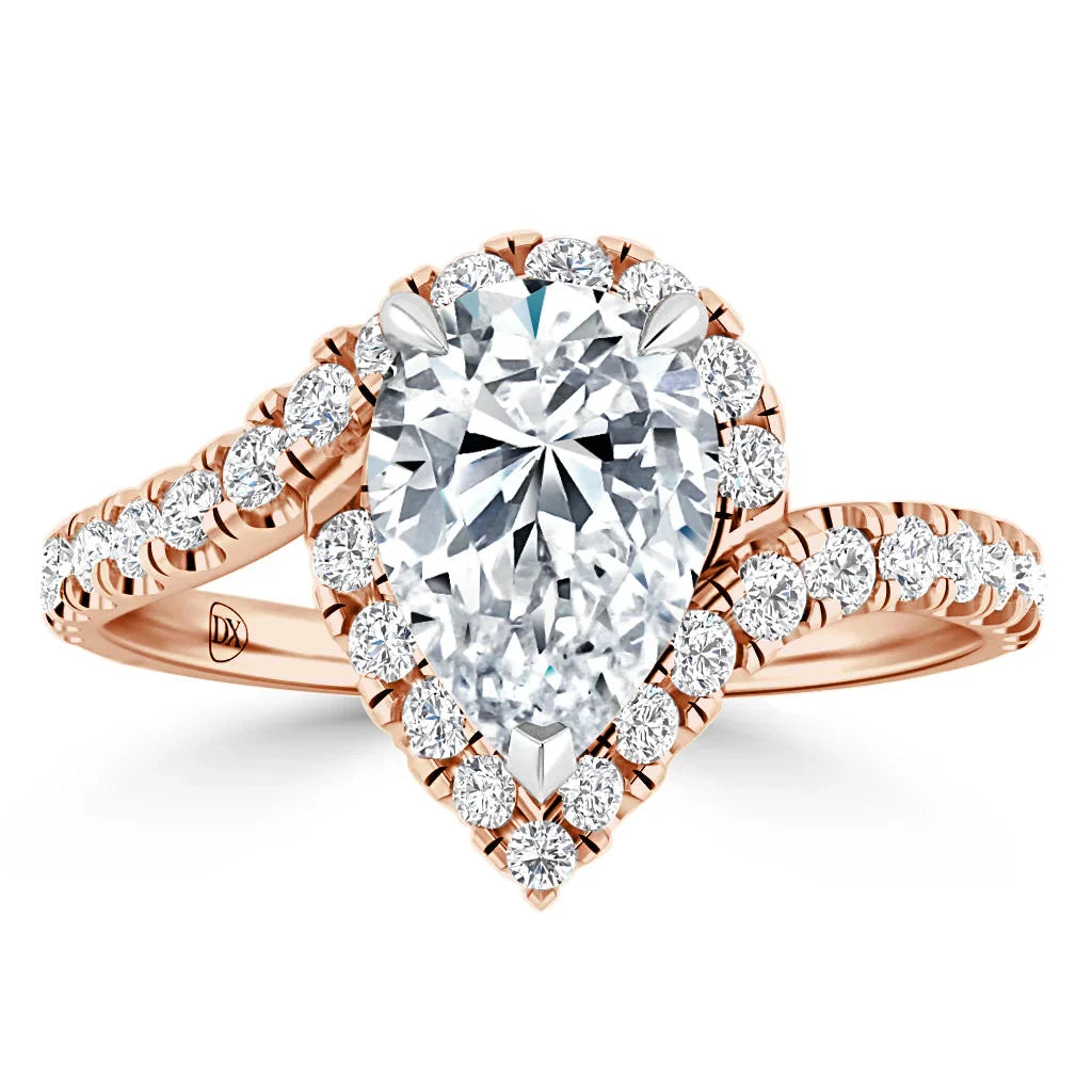 A rose gold ring with a pear-shaped diamond center, halo setting, and diamond-accented band.