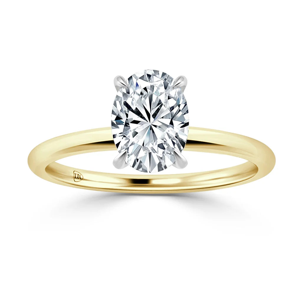 A gold ring with a large oval-cut diamond solitaire set in a four-prong white gold setting.