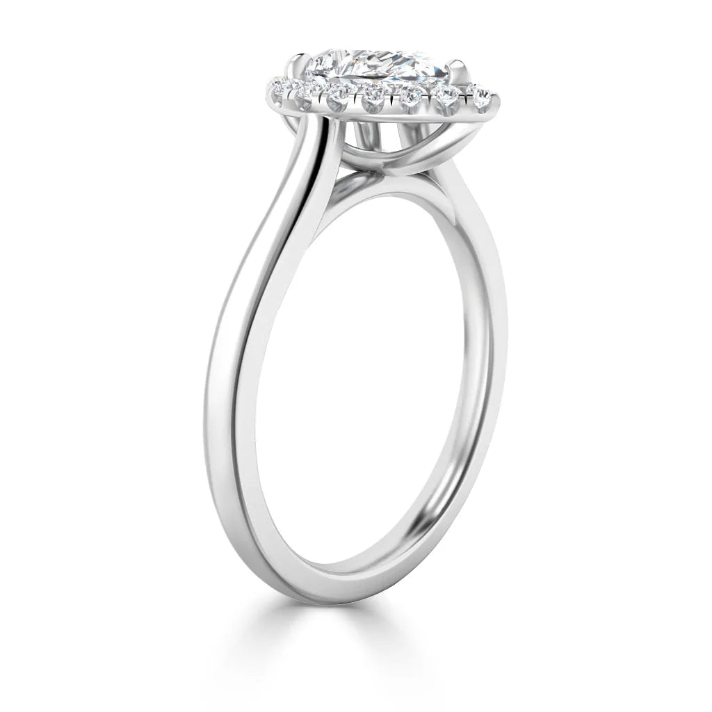 Side view of a white gold ring with an oval diamond center and a halo of smaller diamonds around it.