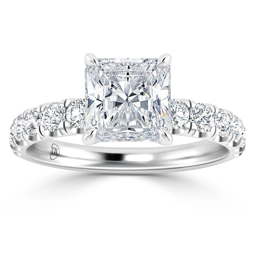 Platinum ring with a large square-cut diamond center and round diamonds set along the band.