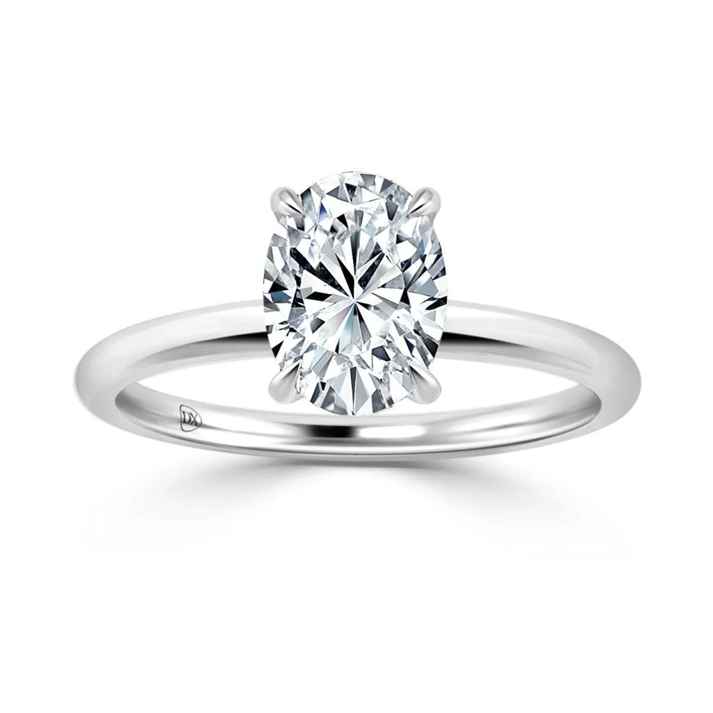 A silver band engagement ring featuring a single oval-cut diamond in a four-prong setting on a white background.
