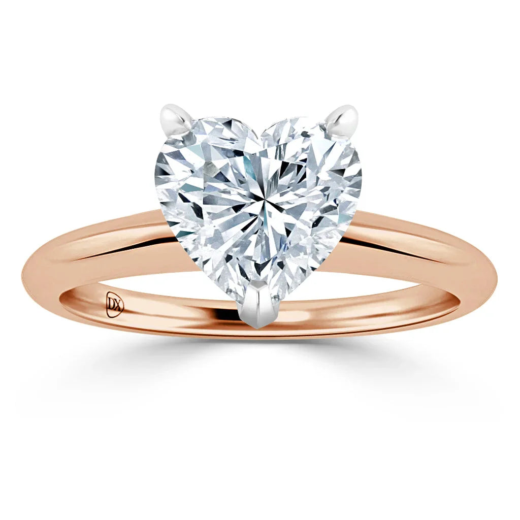 Rose gold ring with a large heart-shaped diamond held by three prongs, viewed from the front.