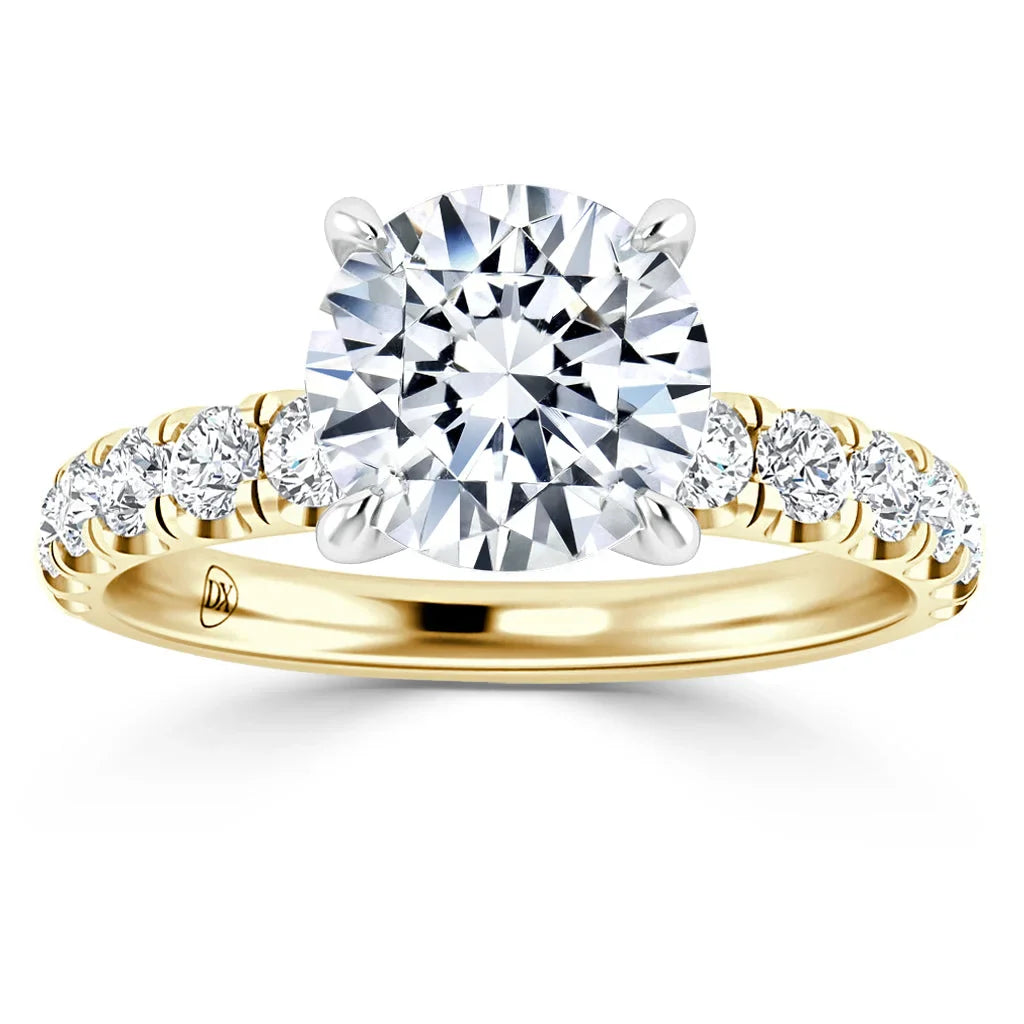 Gold ring with a large round diamond center stone and smaller diamonds set along the band.