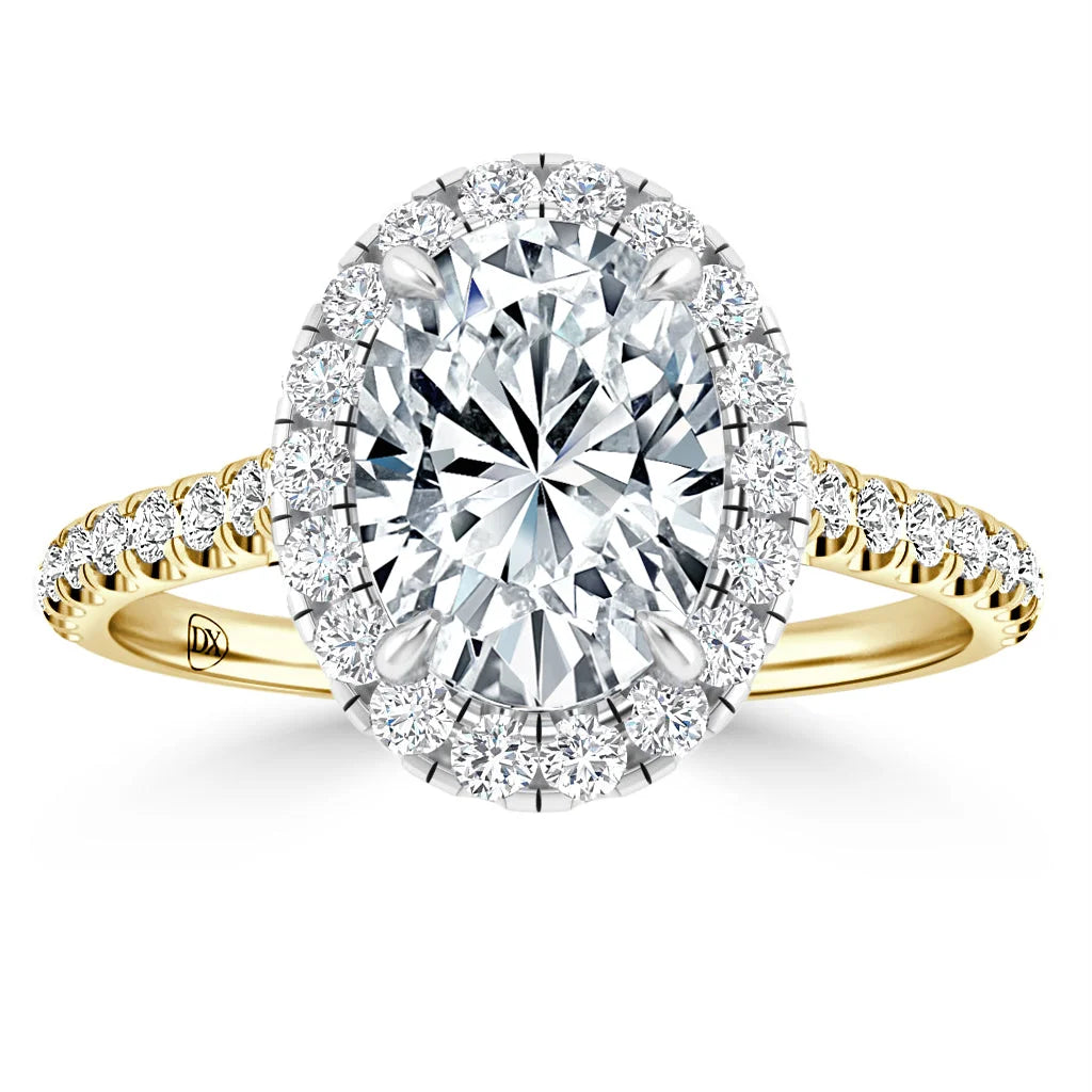 Gold ring with an oval-shaped diamond center, a halo of smaller diamonds, and a diamond-studded band.