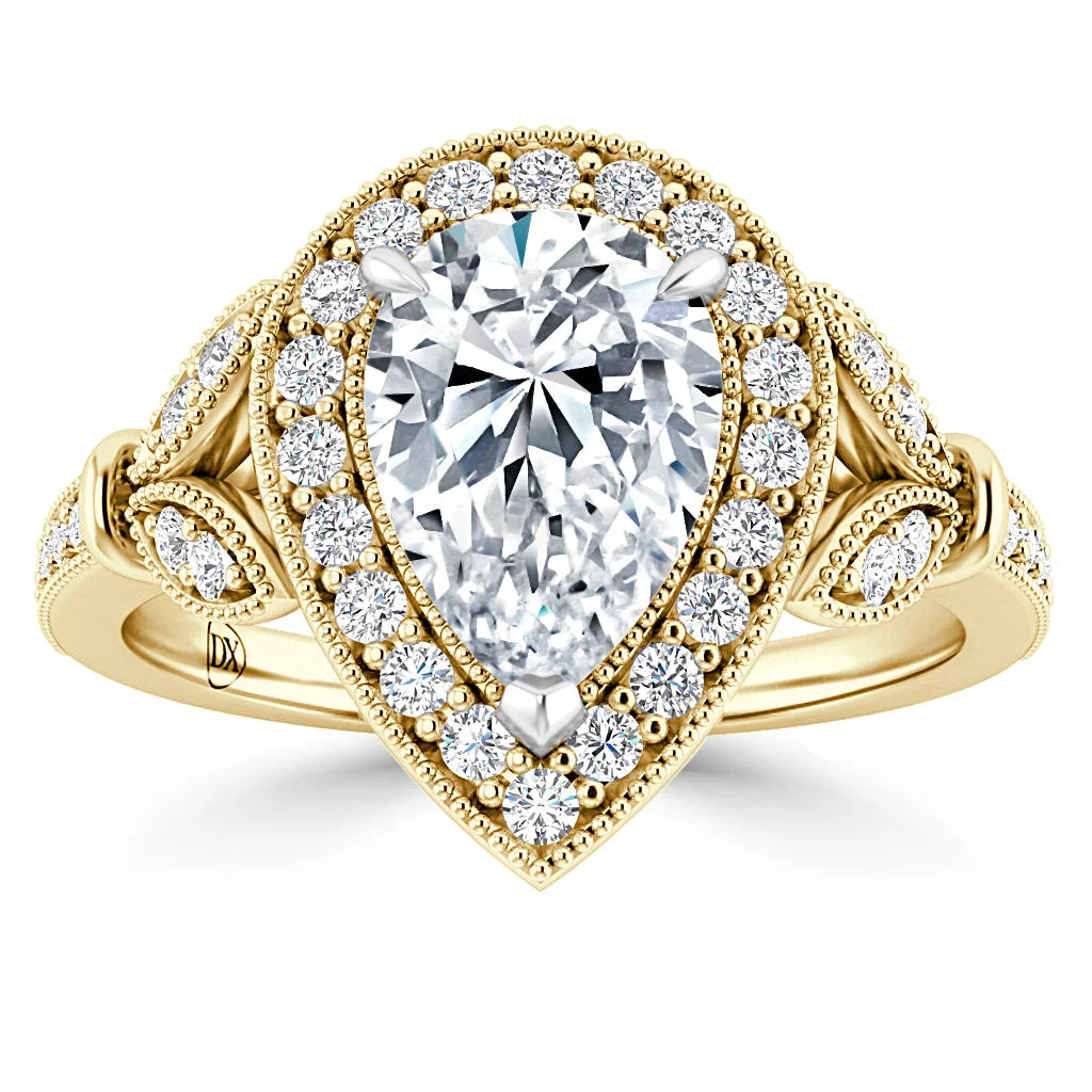 Gold ring with a large pear-shaped diamond center, haloed by smaller diamonds and intricate side detailing.