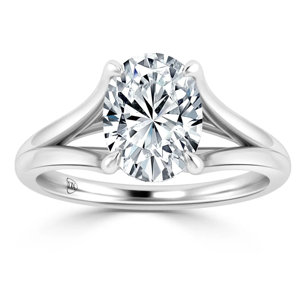 A silver split-shank ring with a large round-cut diamond solitaire set in the center.