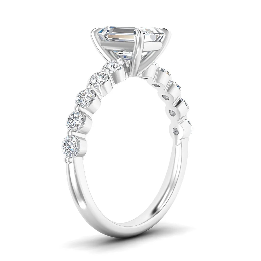 A white gold ring with a large center diamond and smaller diamonds set along the band, shown from a side view.