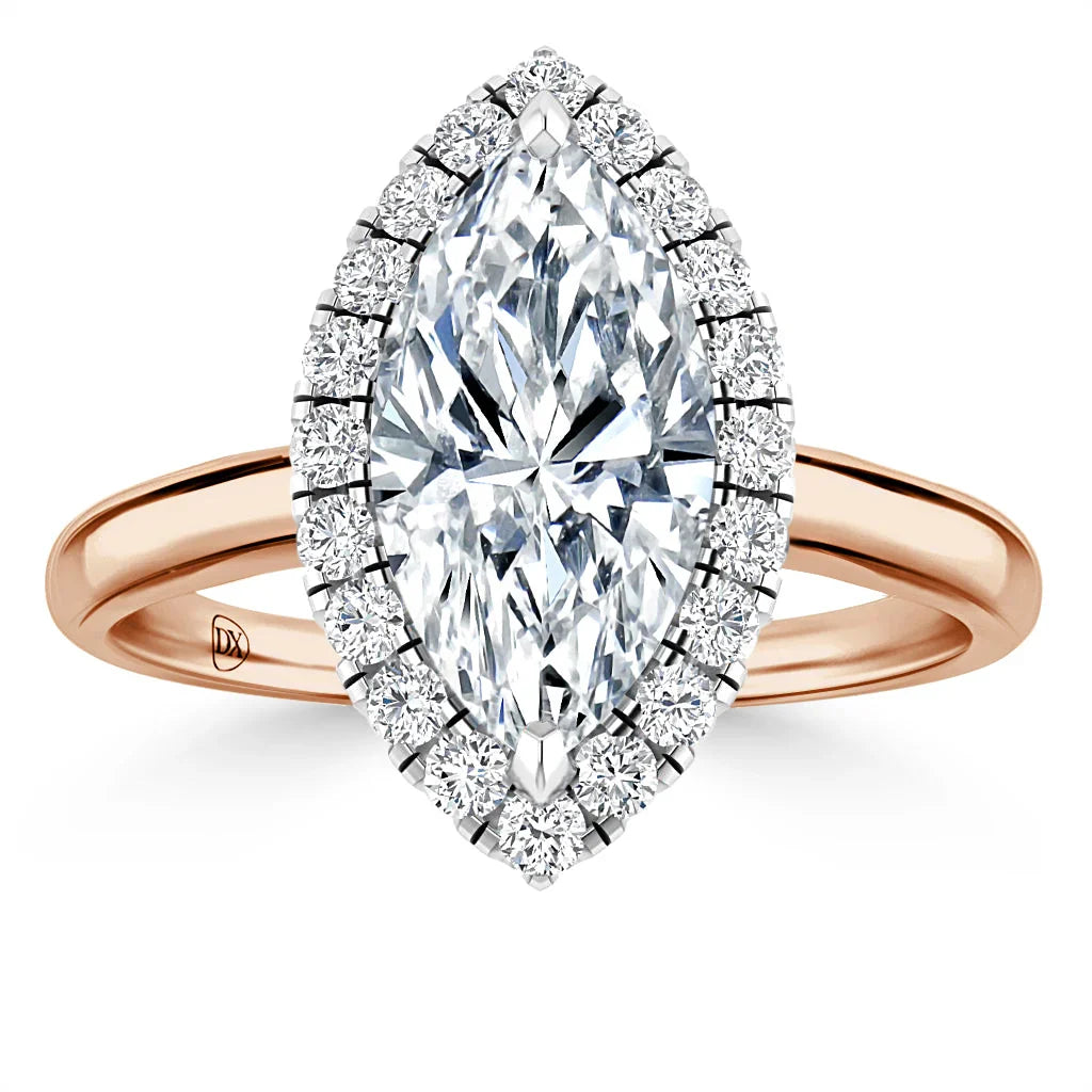 Rose gold ring with marquise-cut diamond center, surrounded by a halo of smaller round diamonds.