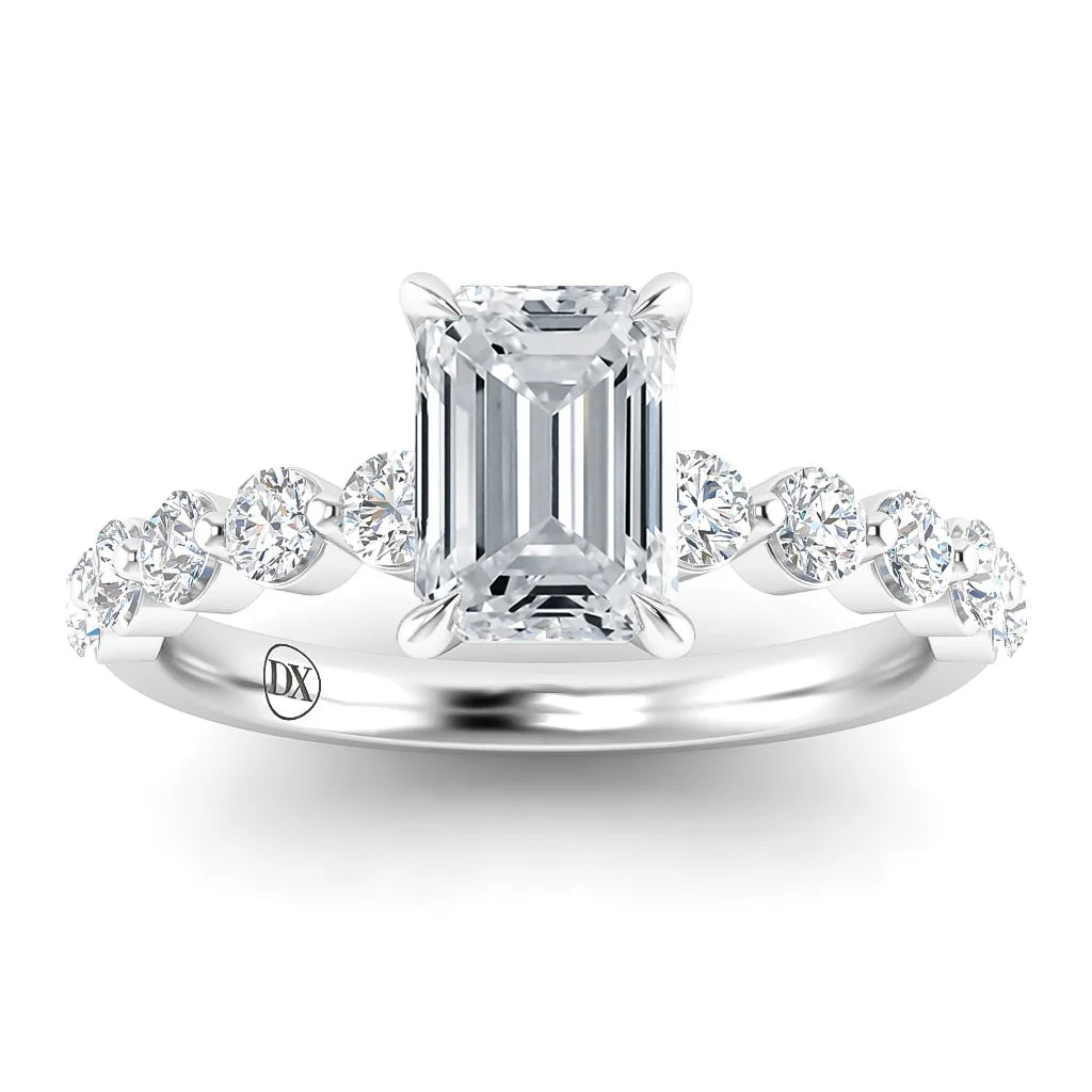 A white gold ring with an emerald-cut center diamond and round diamonds along the band.