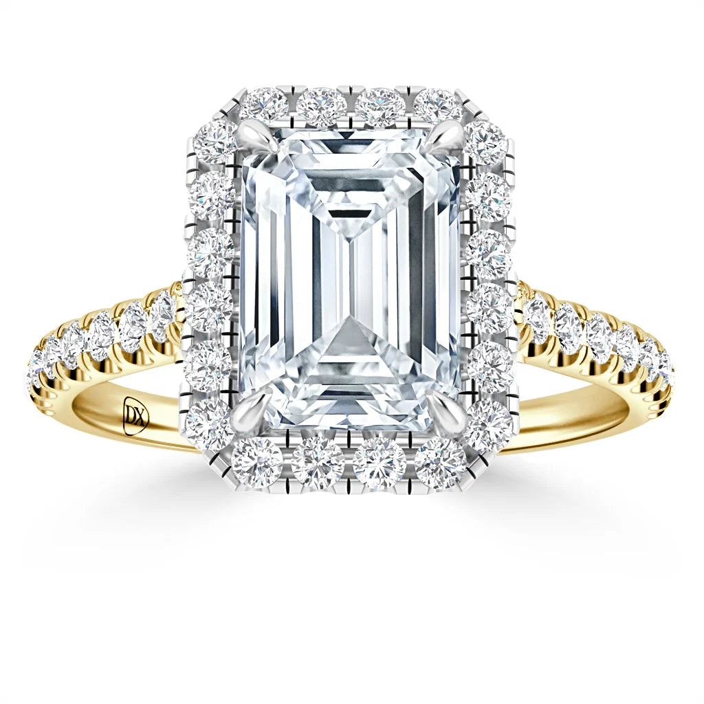 Gold ring with large emerald-cut diamond, haloed by smaller diamonds, and a diamond-encrusted band.