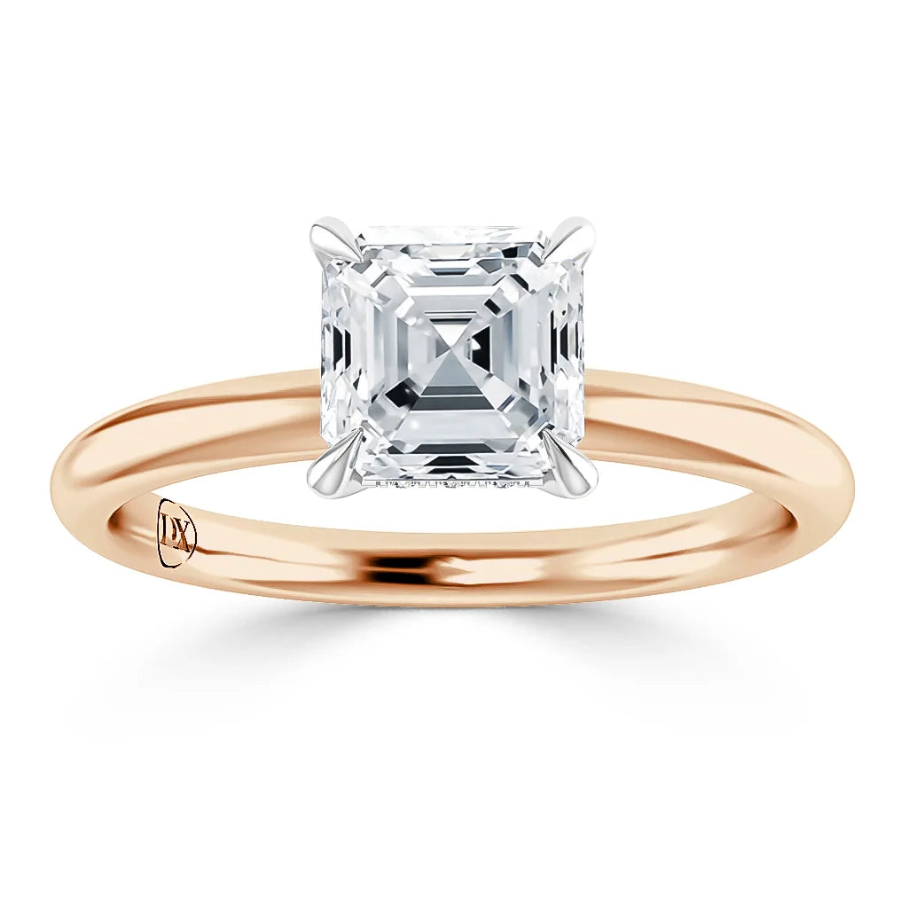 A gold band ring with a square asscher-cut diamond solitaire set in a four-prong setting.