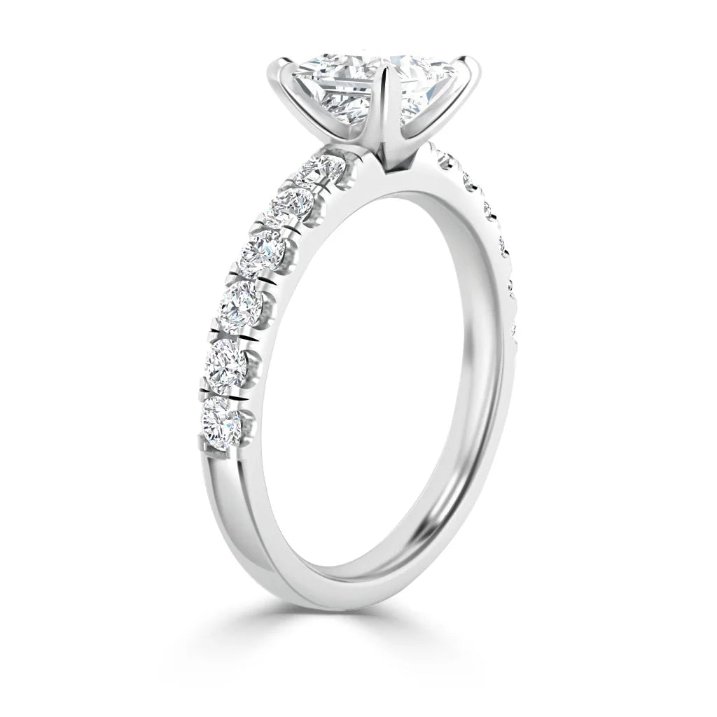 Side view of a white gold ring with a large center diamond and smaller diamonds along the band.