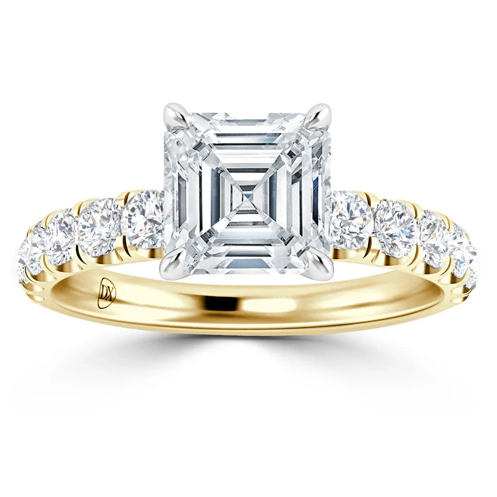Gold ring with a large square-cut diamond center and round diamonds set along the band.