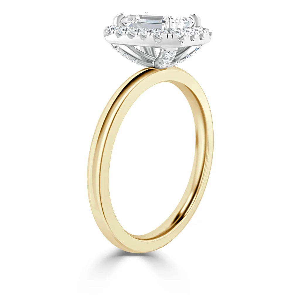 Gold band ring with a large rectangular diamond and a halo of smaller diamonds in a white gold setting.
