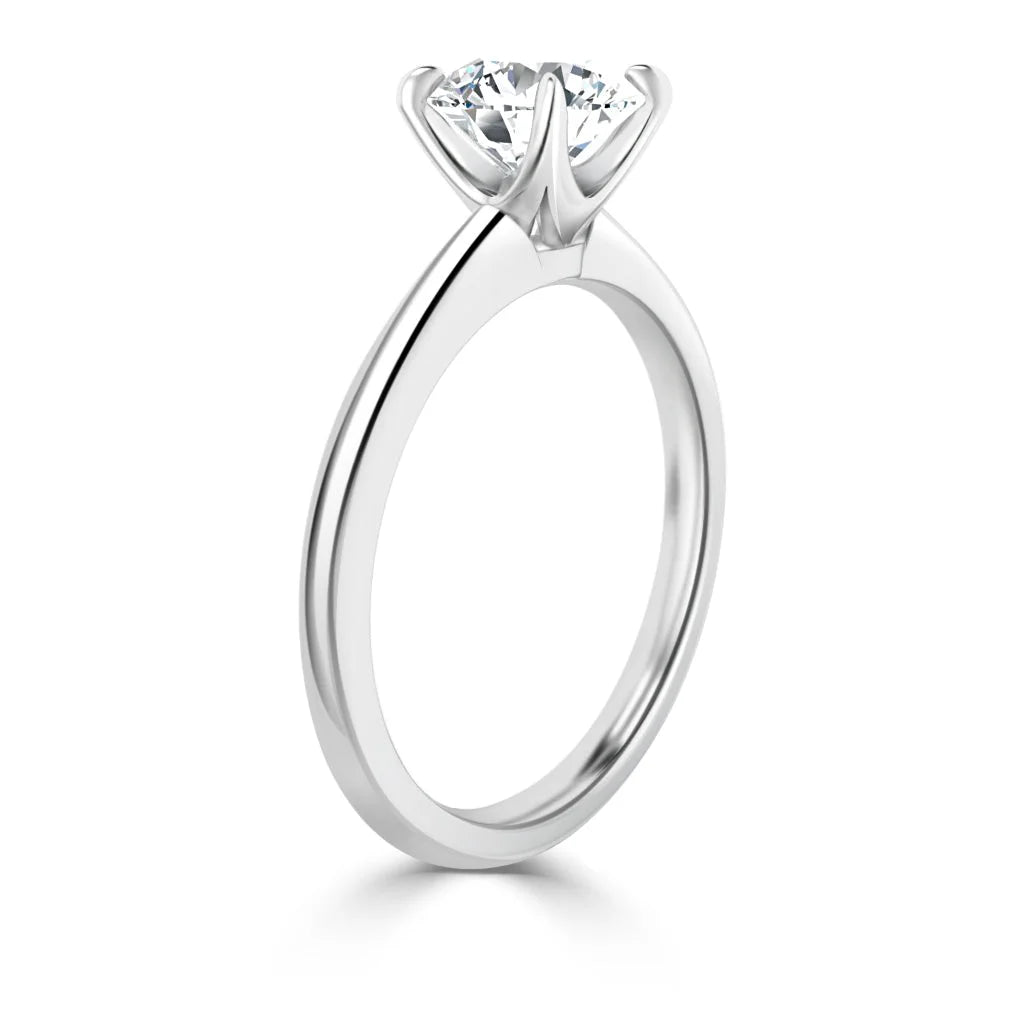 A solitaire diamond engagement ring with a round-cut diamond set in a classic six-prong white gold band.