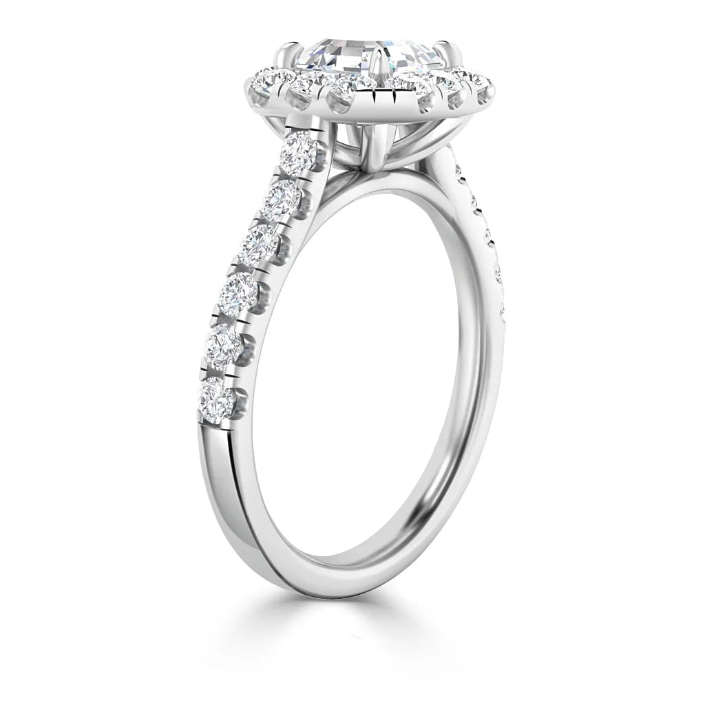 White gold ring with a round diamond halo setting and diamonds set along the thin band.