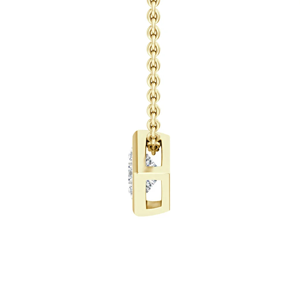 Gold pendant necklace with a vertical rectangular frame and a round diamond suspended inside, on a gold chain.