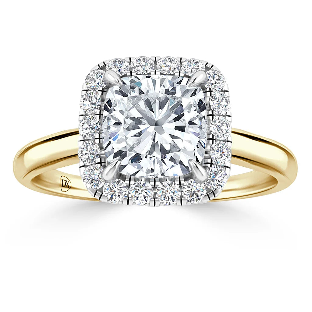 Gold band ring with a large cushion-cut diamond, surrounded by two halos of smaller diamonds.