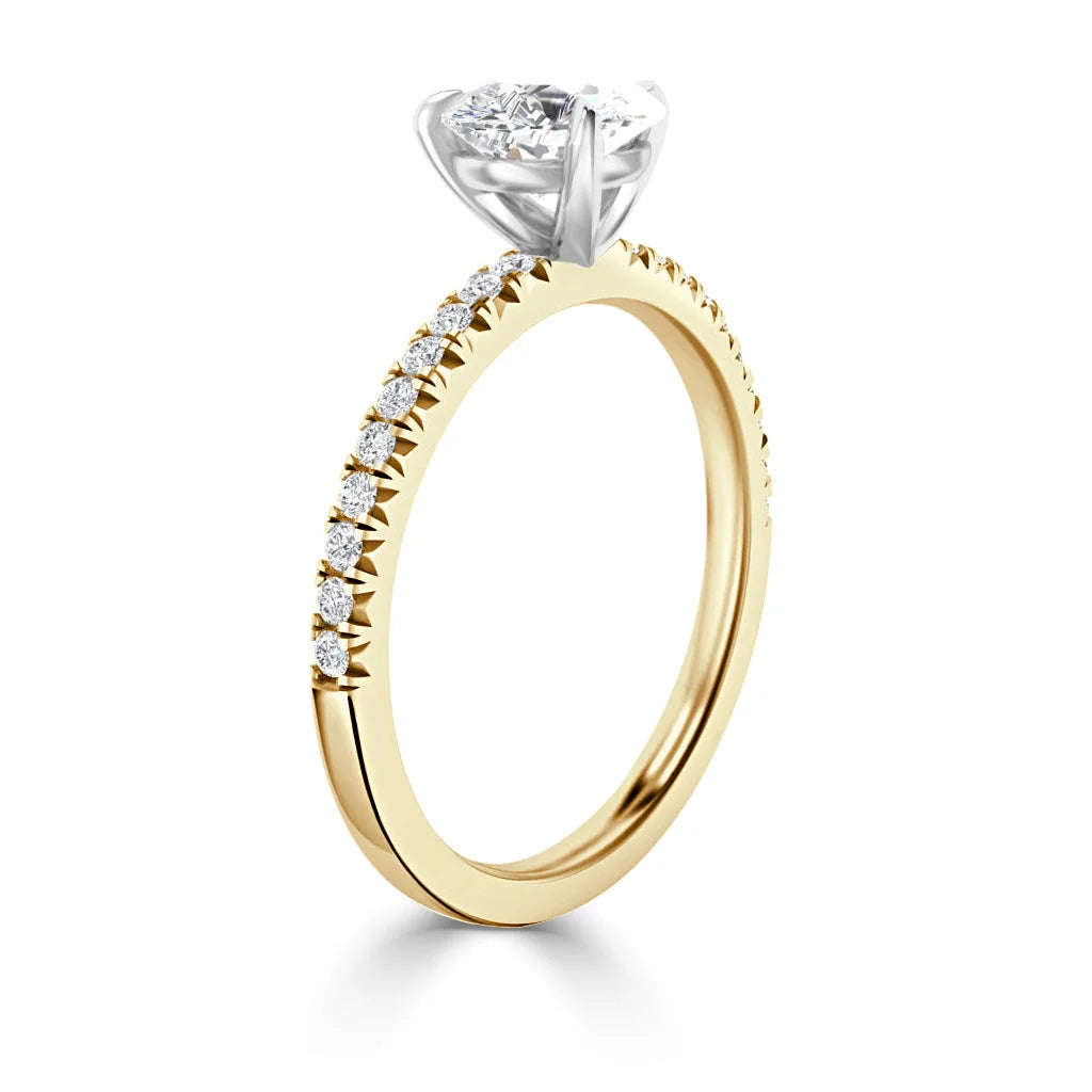 Gold ring with small diamonds along the band and a large round diamond in a white metal prong setting.