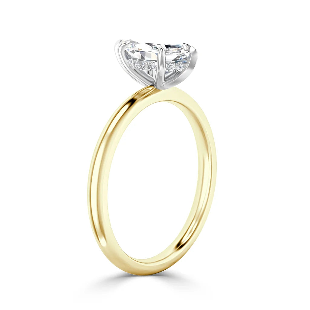 Gold band solitaire ring with a large round diamond held by a four-prong white gold setting, side view.