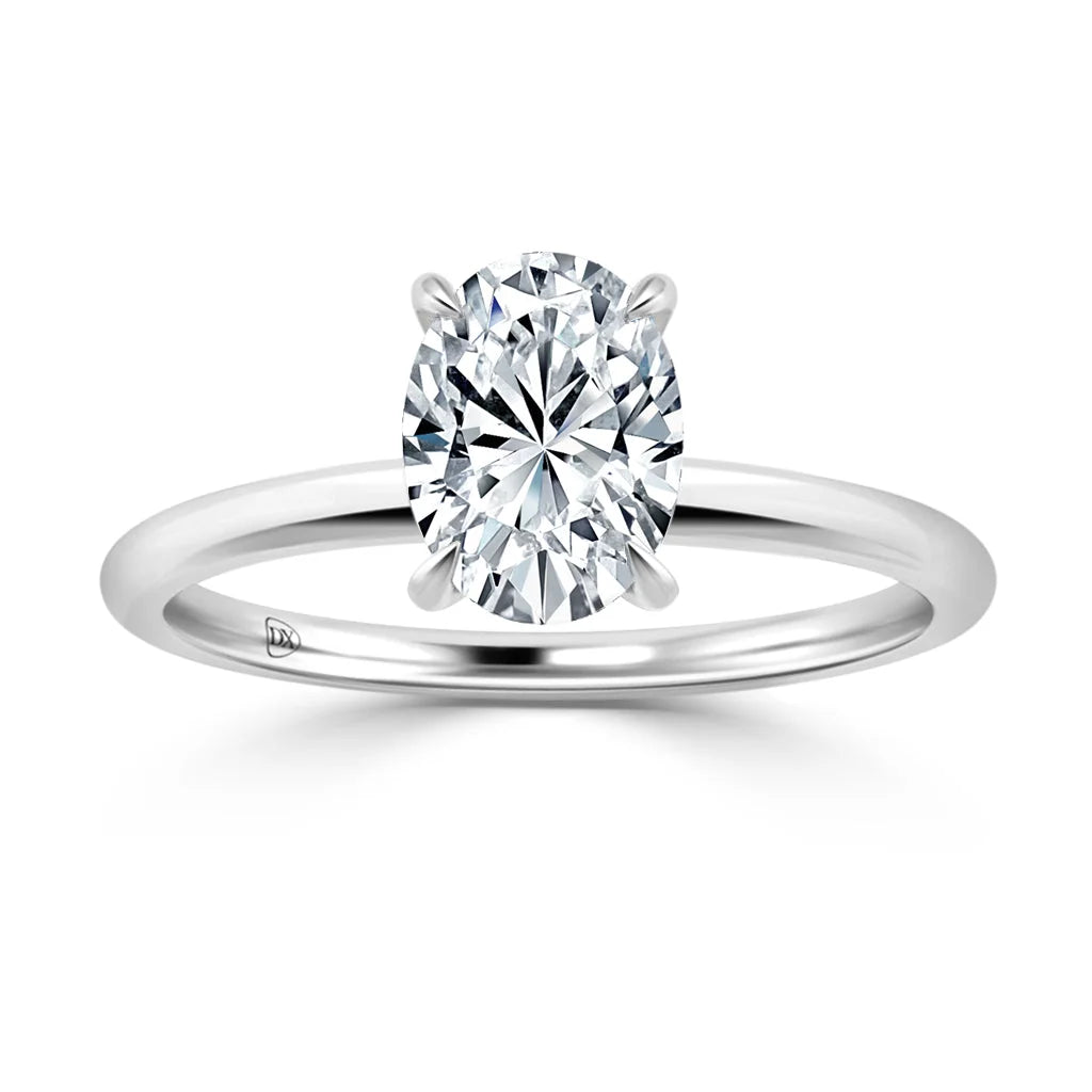A silver ring with a large oval-cut diamond in a four-prong solitaire setting on a plain band.