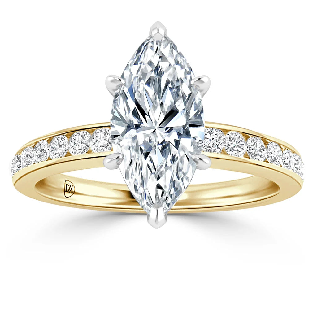 Marquise-cut diamond ring with a yellow gold band, featuring small diamonds along the band’s upper side.