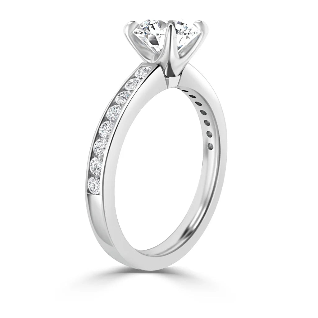 A white gold ring with a large round diamond solitaire and smaller diamonds set along the band.