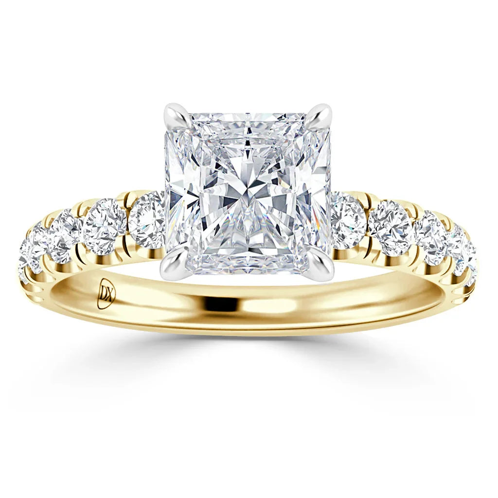Gold ring with a large square-cut diamond center and smaller round diamonds along the band.
