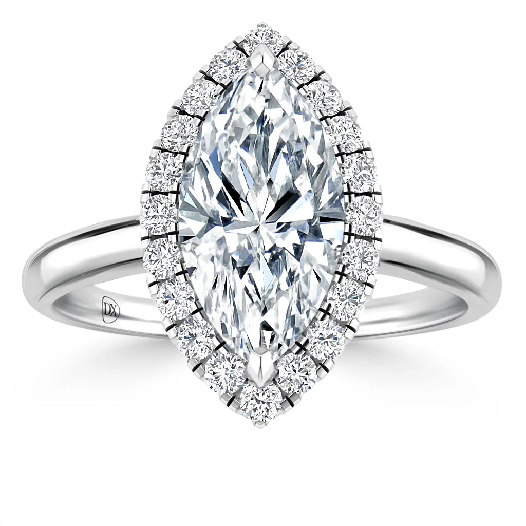 Marquise-cut diamond ring with a halo of smaller diamonds on a sleek white gold band, viewed from above.