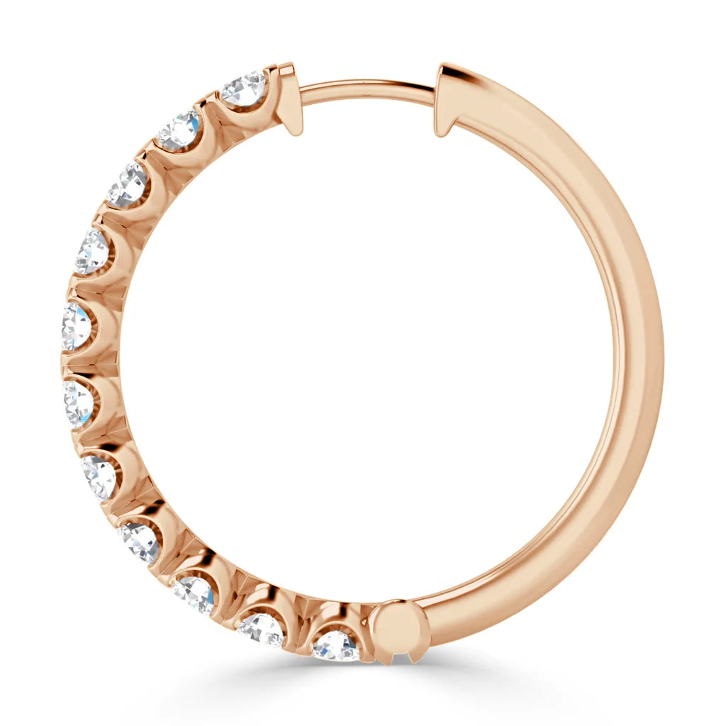A rose gold hoop earring with embedded round white gemstones along half of the outer edge.