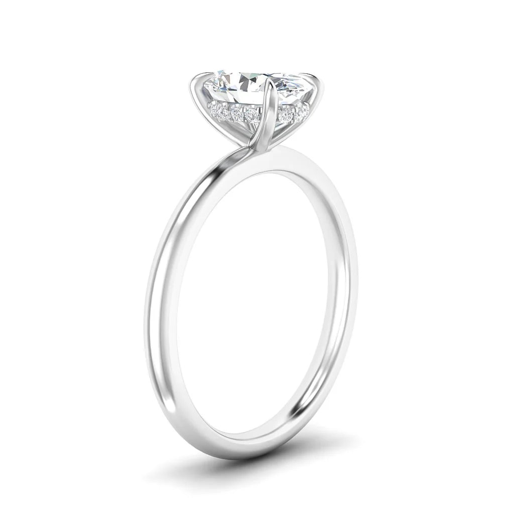 A silver ring with a round solitaire diamond, elevated setting, and small accent diamonds around the base.
