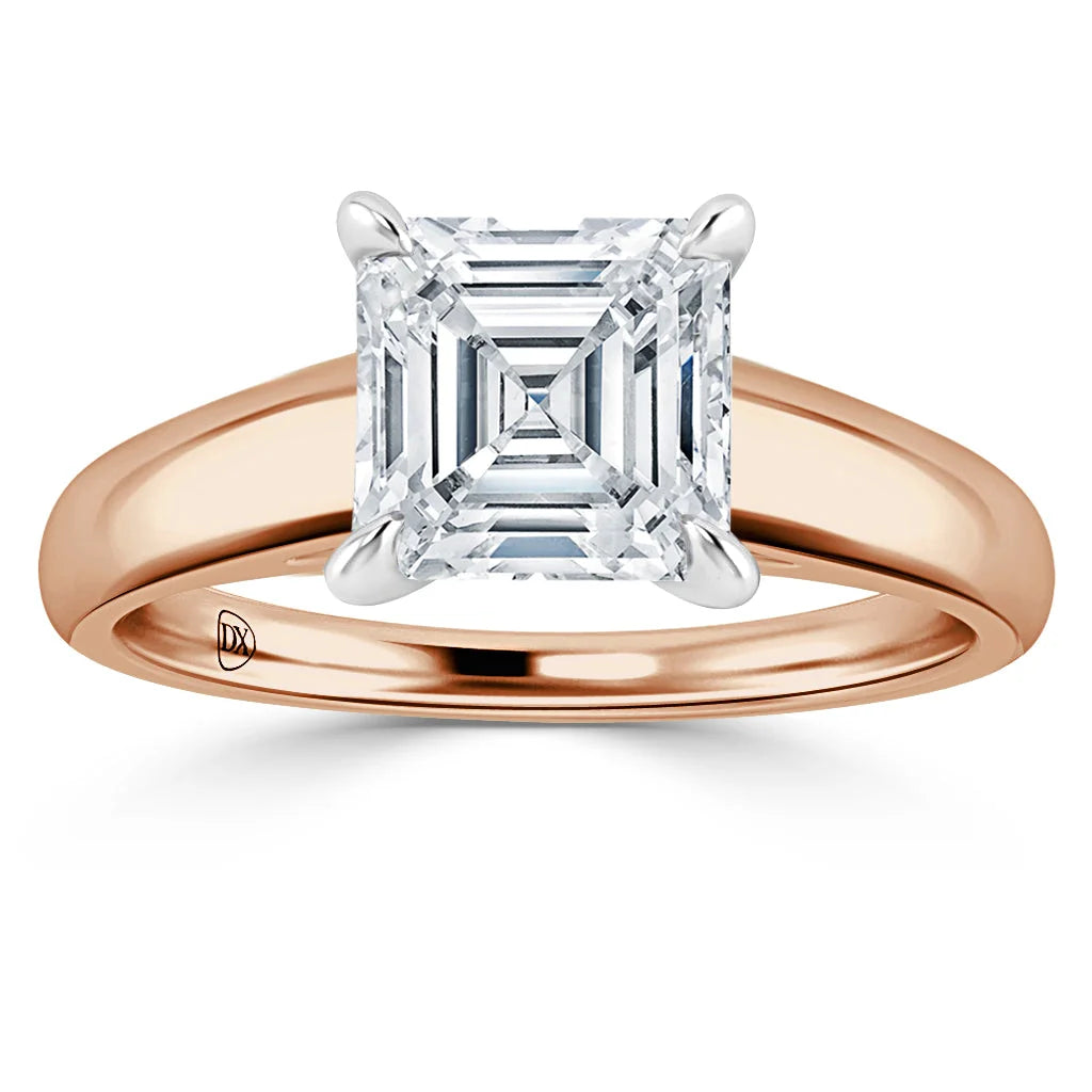 A rose gold ring with a large square-cut diamond set in a four-prong white gold setting.