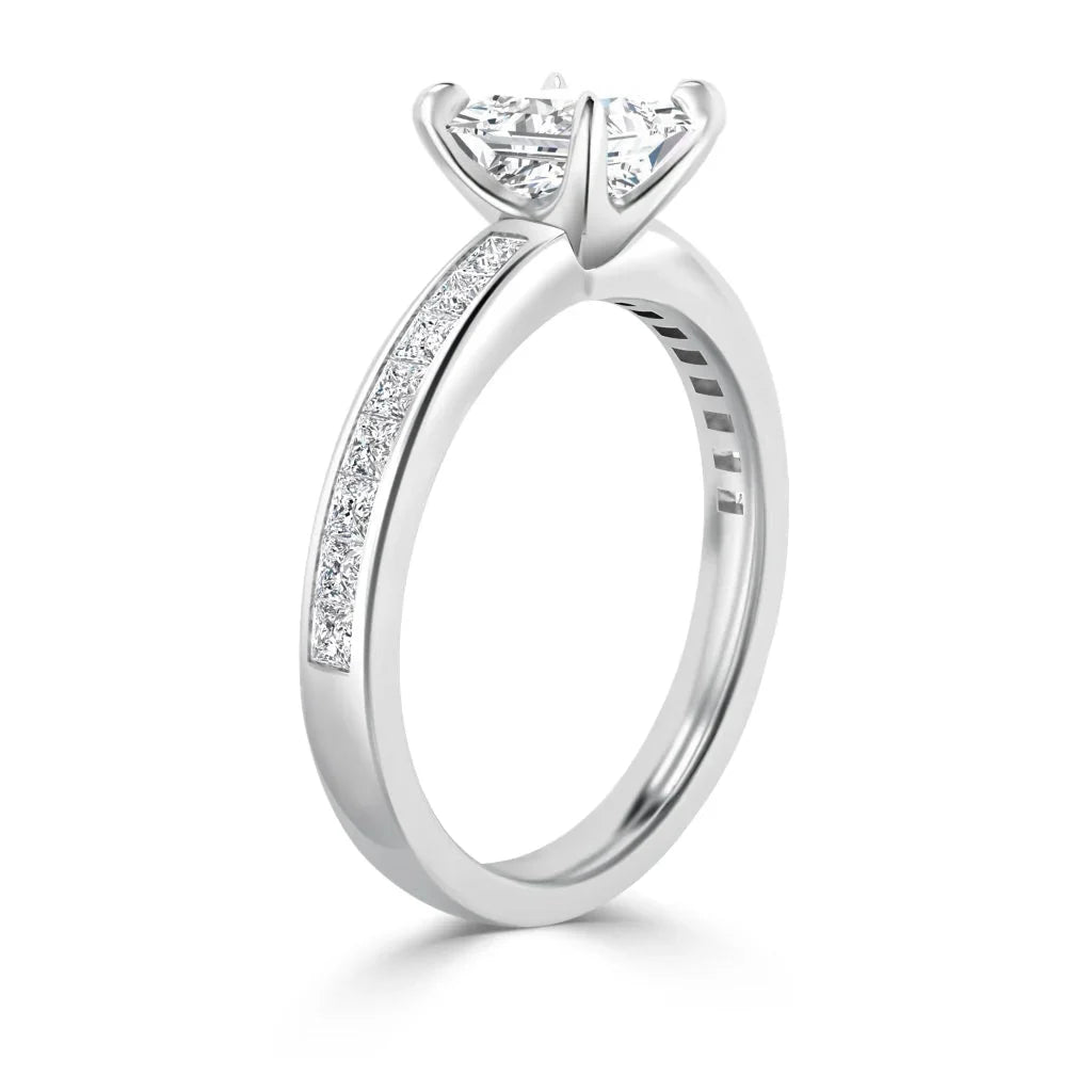 White gold ring with a large solitaire diamond and smaller diamonds set along half of the band.