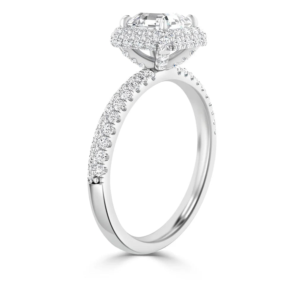 A white gold ring with a large oval diamond center and small diamonds on the band and setting.