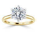 Gold band solitaire ring with a large round diamond held by six prongs, shown on a white background.