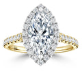 A marquise-cut diamond ring with a halo and pavé band set in yellow gold, shown on a white background.