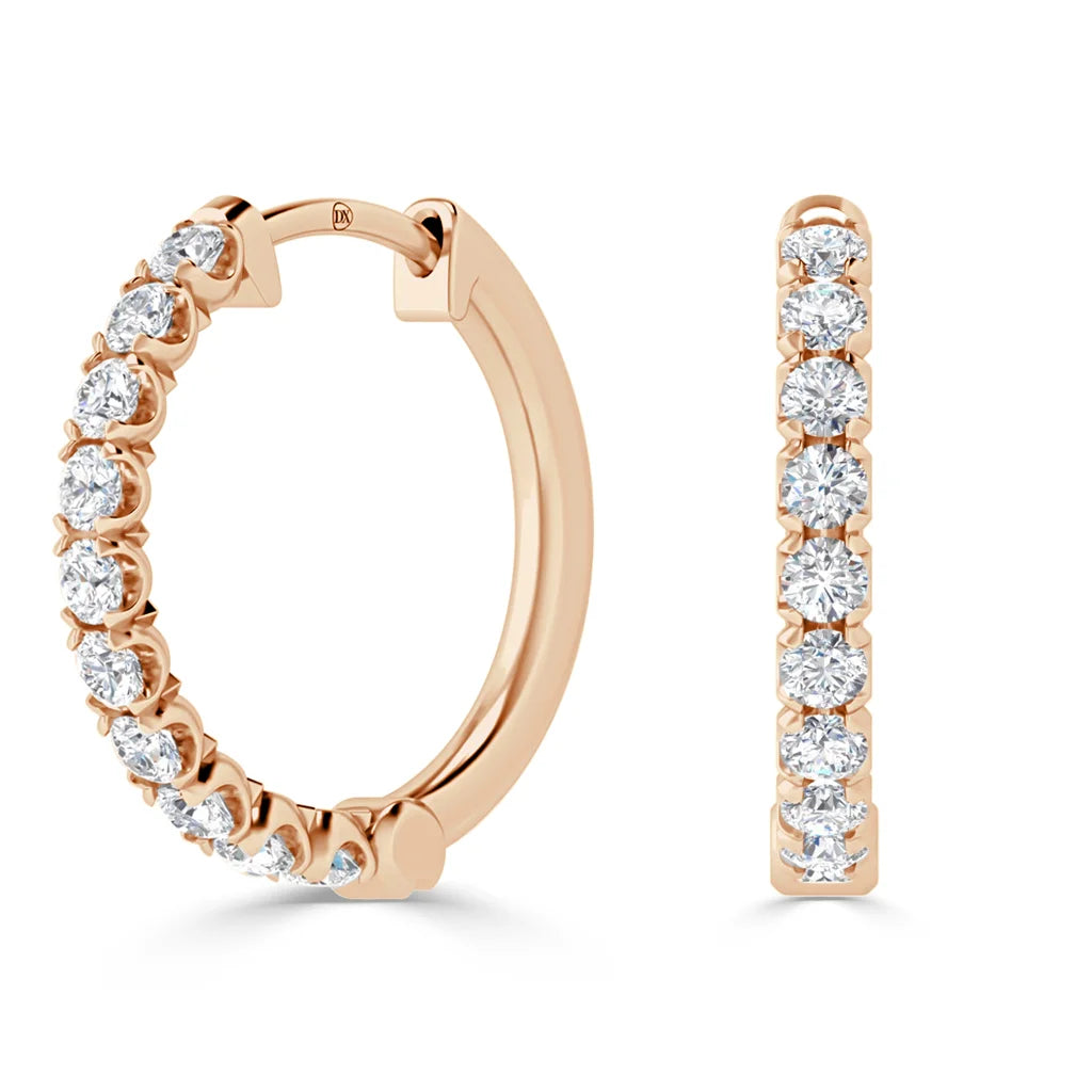 Rose gold hoop earrings with a row of round, white diamonds set along the outer edge.