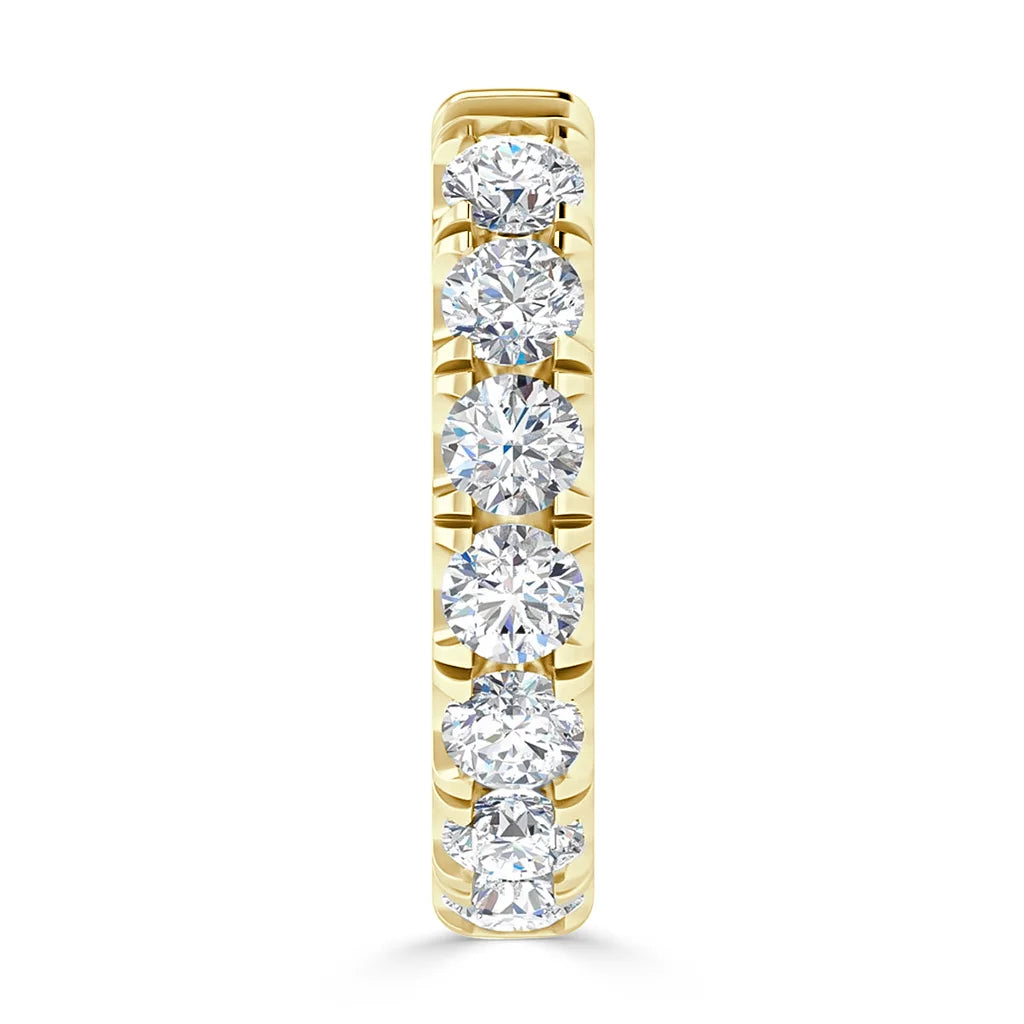 A gold ring set with seven round, sparkling white diamonds in a vertical row on the band.
