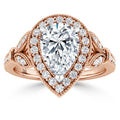Rose gold ring with a large pear-shaped diamond, haloed by small round diamonds and intricate detailing.