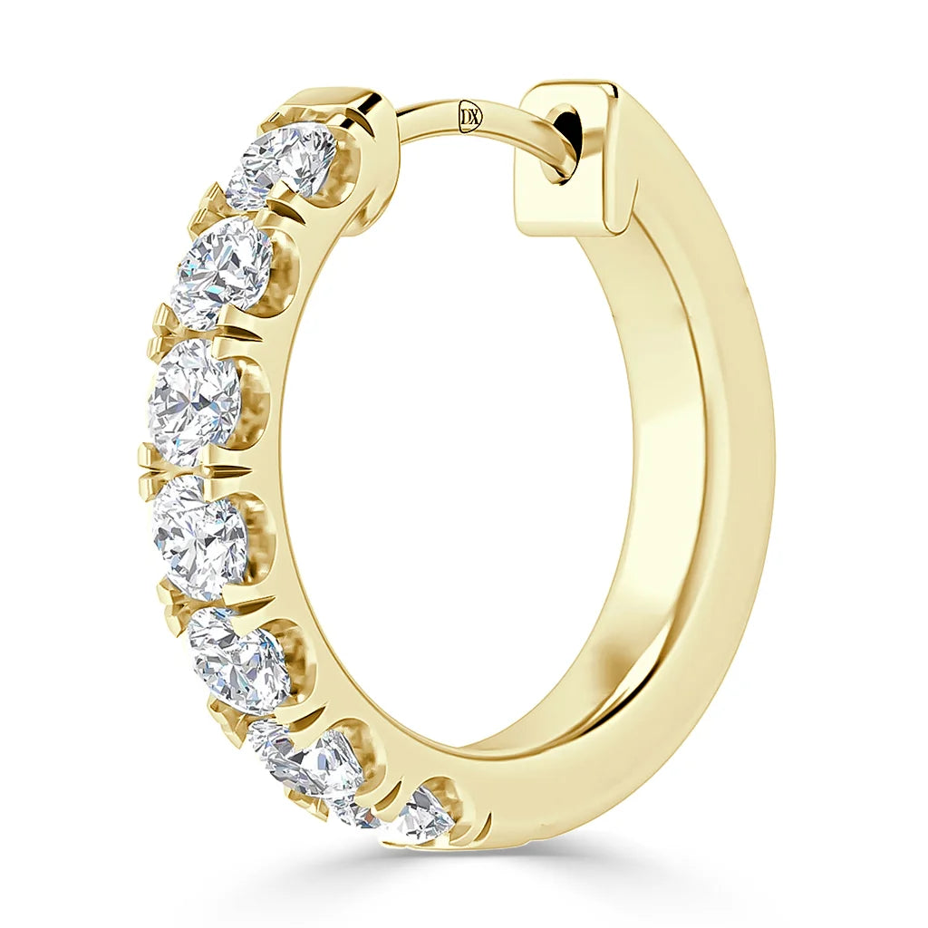 A gold hoop earring adorned with a row of round, sparkling white diamonds along the front edge.