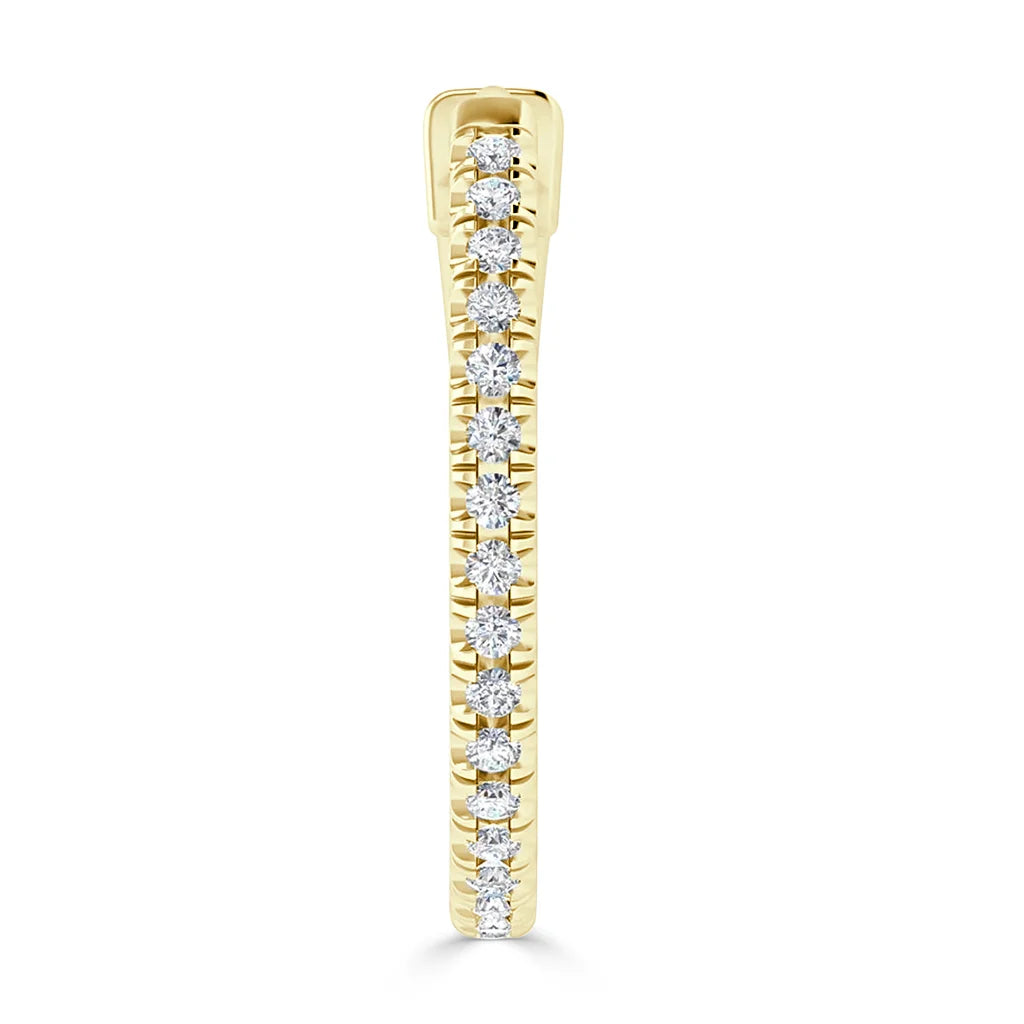 A gold ring set with a row of round white diamonds in a vertical channel setting, viewed from the side.