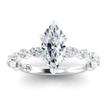 A marquise-cut diamond ring with a twisted band set with smaller round diamonds on a white gold band.