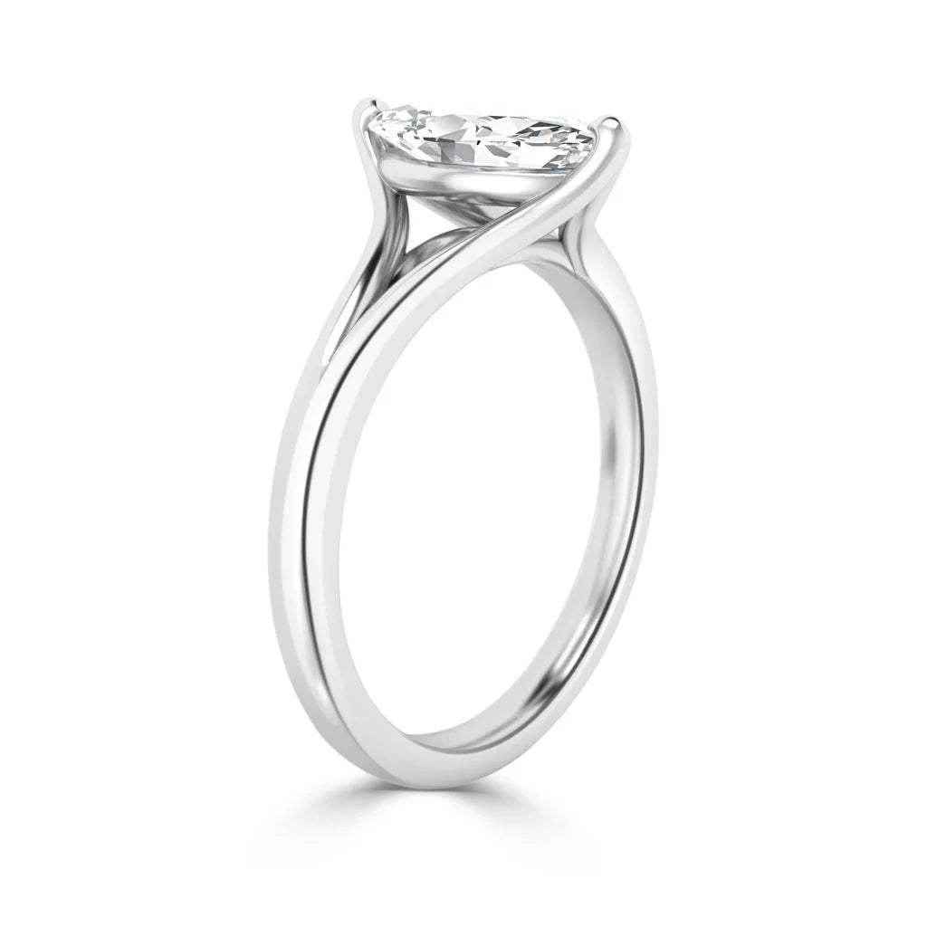 A solitaire oval diamond ring with a slim, twisted white gold band on a plain white background.